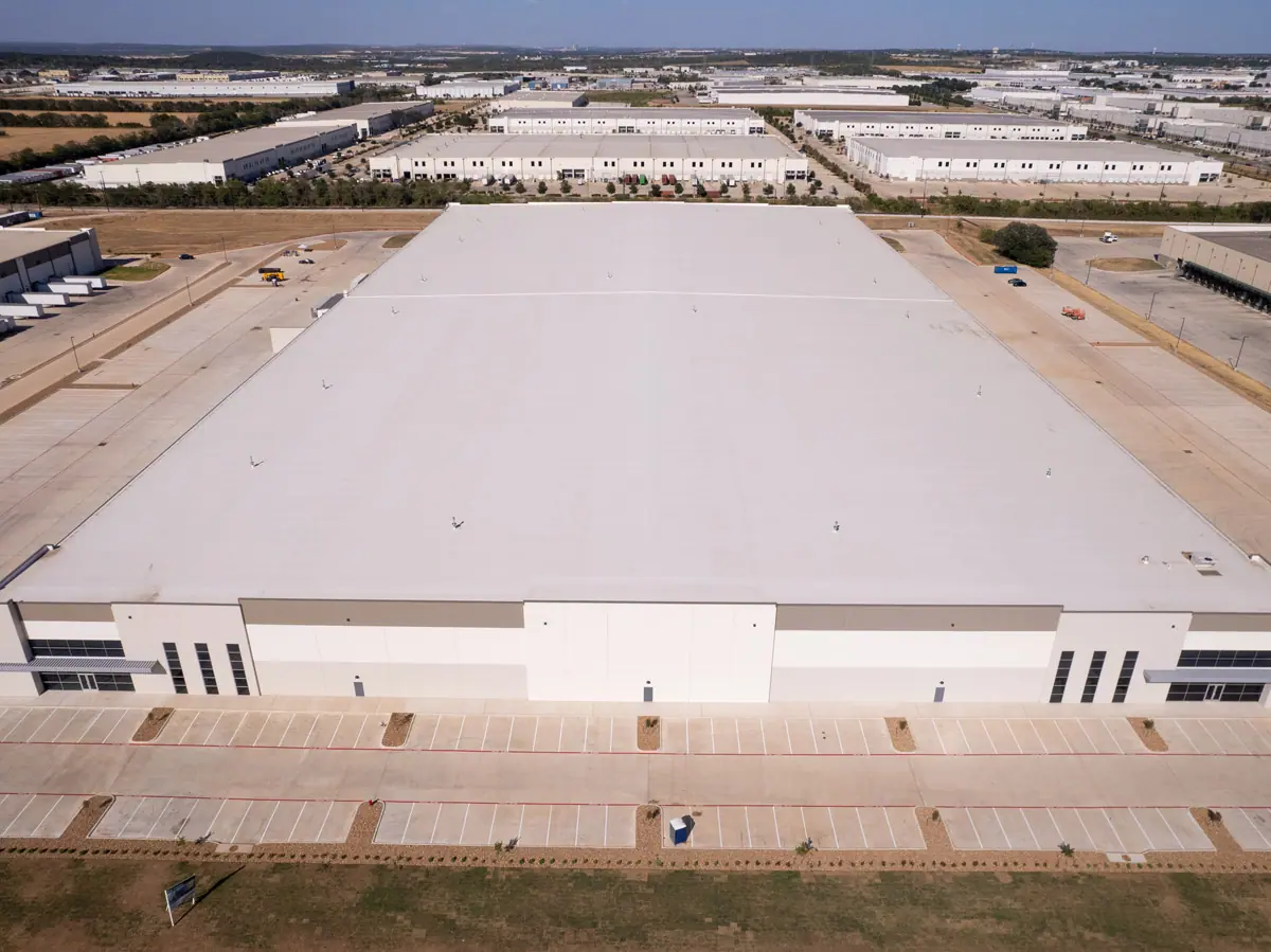 Aerial view of a large warehouse with a finished white TPO roof – TPO roofs project gallery