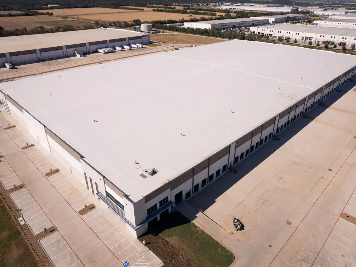 Aerial view of a large warehouse with a finished white TPO roof – TPO roofs project gallery
