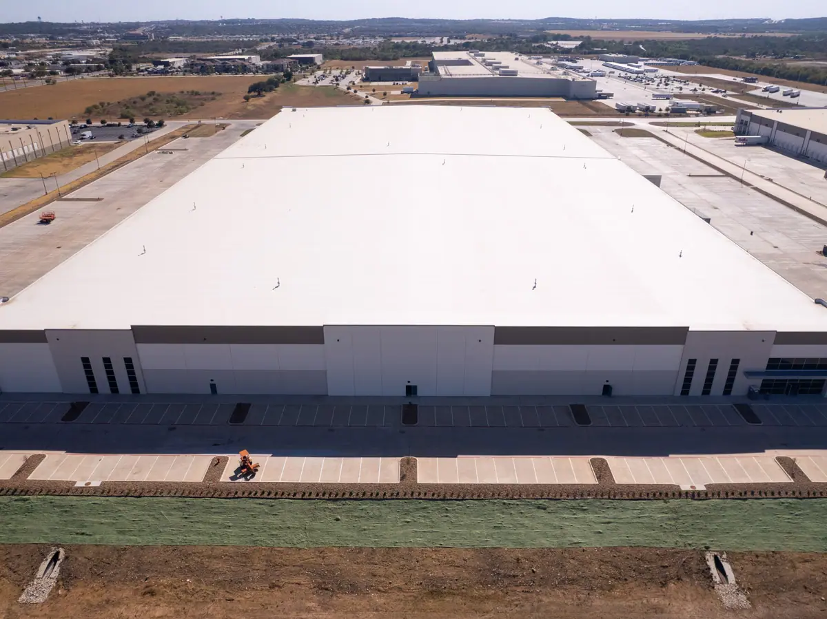 Aerial view of a large warehouse with a finished white TPO roof – TPO roofs project gallery