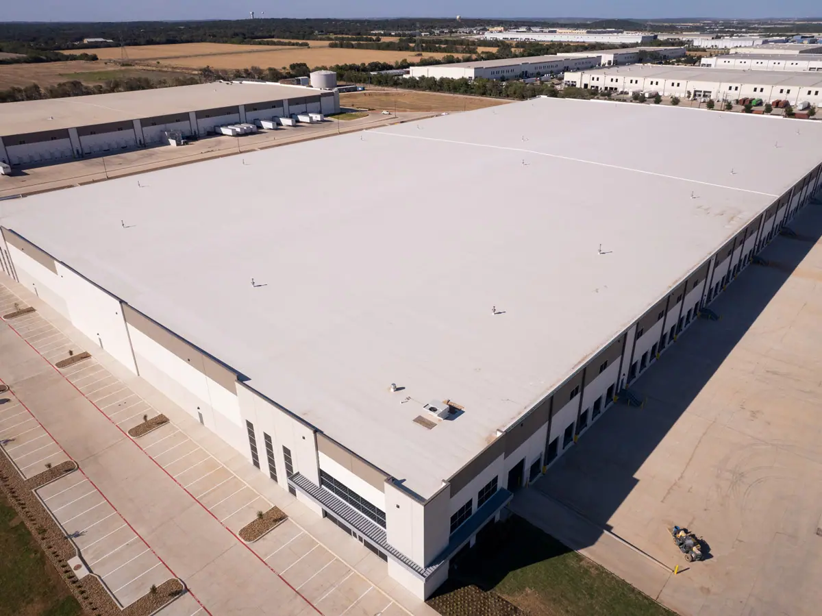 Aerial view of a large warehouse with a finished white TPO roof – TPO roofs project gallery