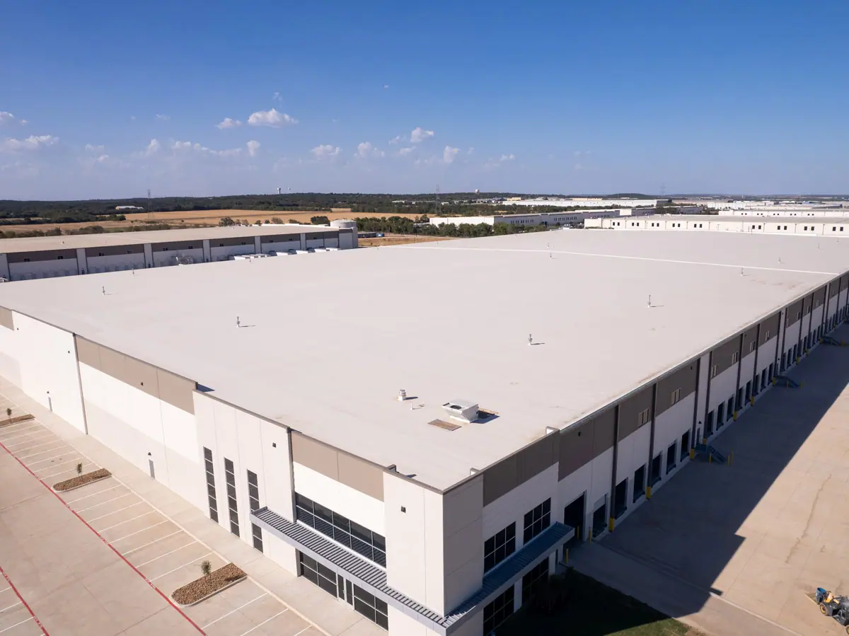 Aerial view of a large warehouse with a finished white TPO roof – TPO roofs project gallery