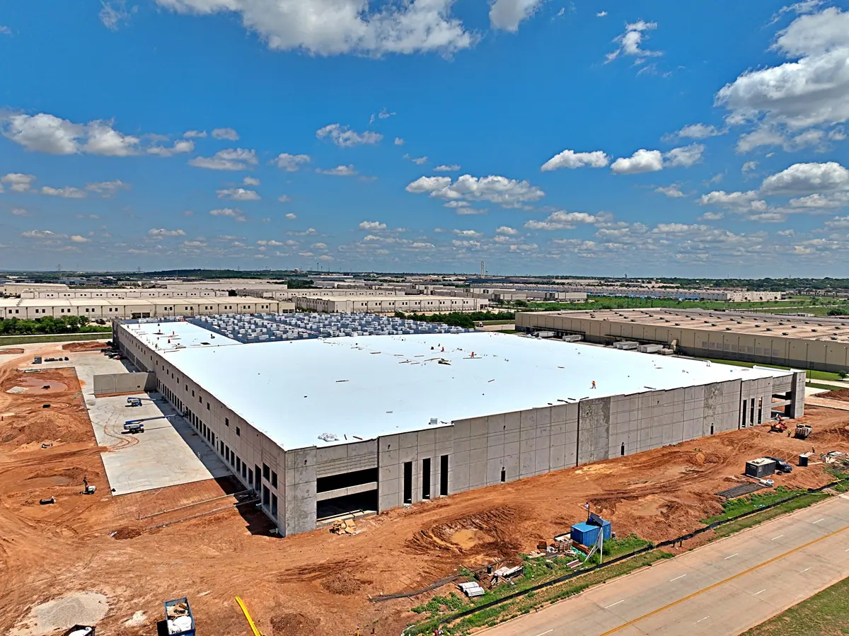 Aerial view of a large warehouse during its TPO roof installation – TPO roofs project gallery