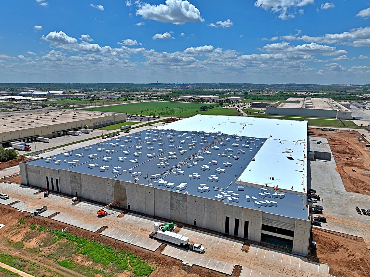 Aerial view of a large warehouse during its TPO roof installation – TPO roofs project gallery