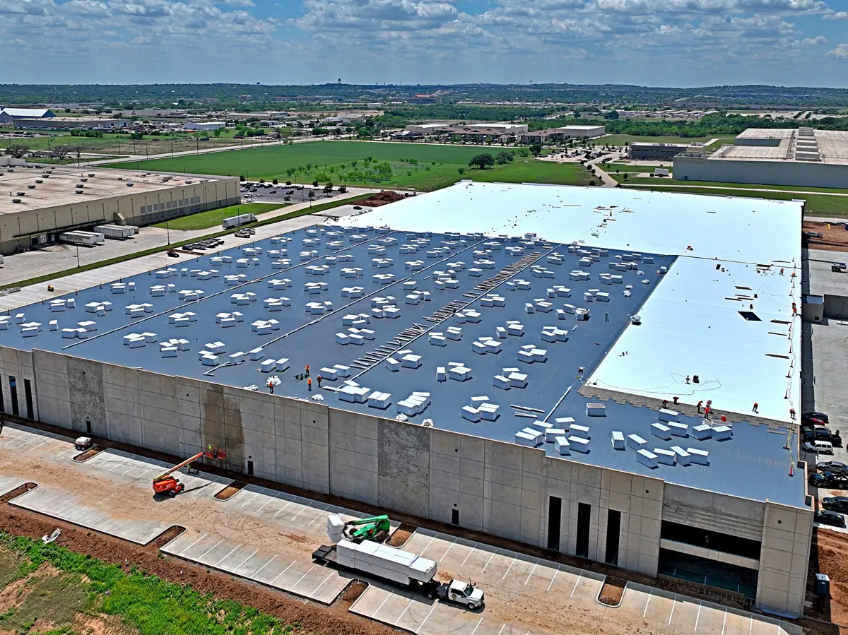 Aerial view of a large warehouse during its TPO roof installation – TPO roofs project gallery