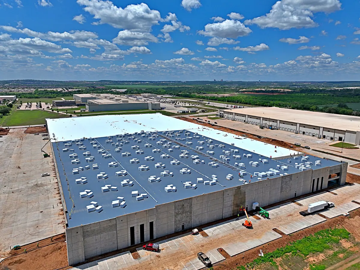 Aerial view of a large warehouse during its TPO roof installation – TPO roofs project gallery