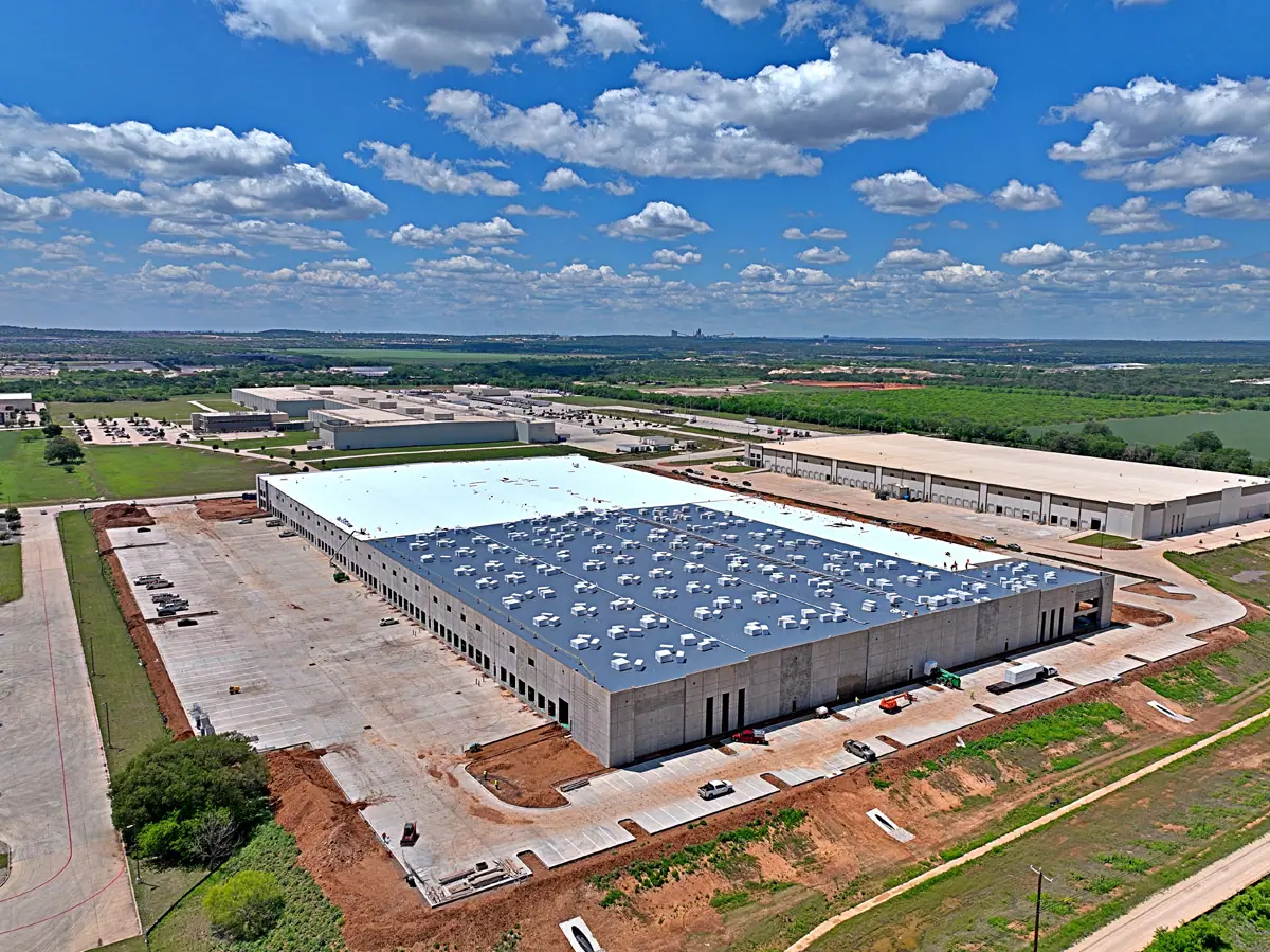 Aerial view of a large warehouse during its TPO roof installation – TPO roofs project gallery