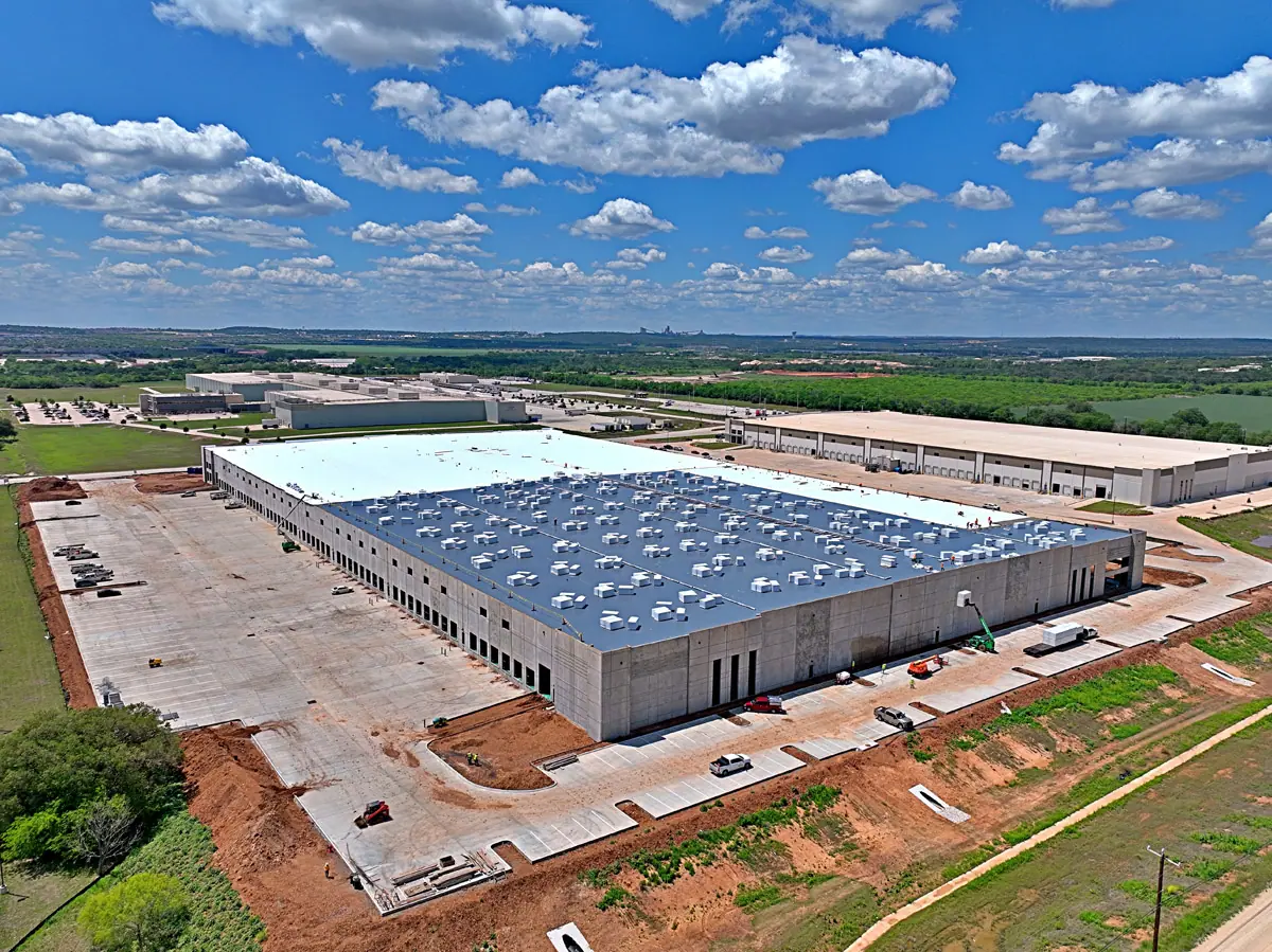 Aerial view of a large warehouse during its TPO roof installation – TPO roofs project gallery