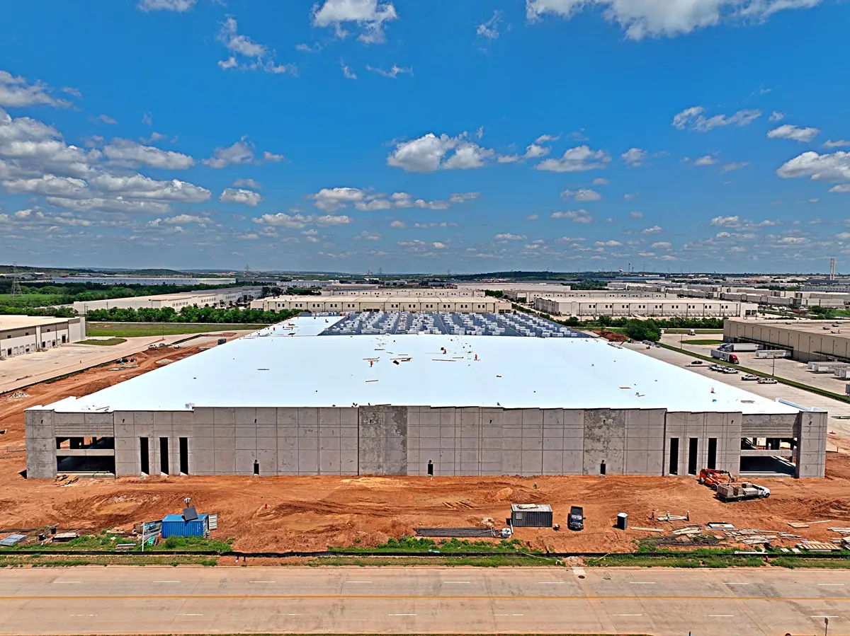 Aerial view of a large warehouse during its TPO roof installation – TPO roofs project gallery