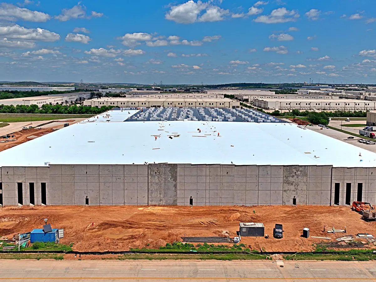 Aerial view of a large warehouse during its TPO roof installation – TPO roofs project gallery