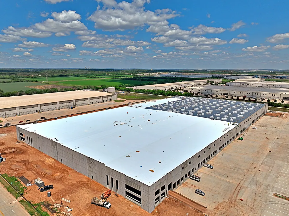 Aerial view of a large warehouse during its TPO roof installation – TPO roofs project gallery