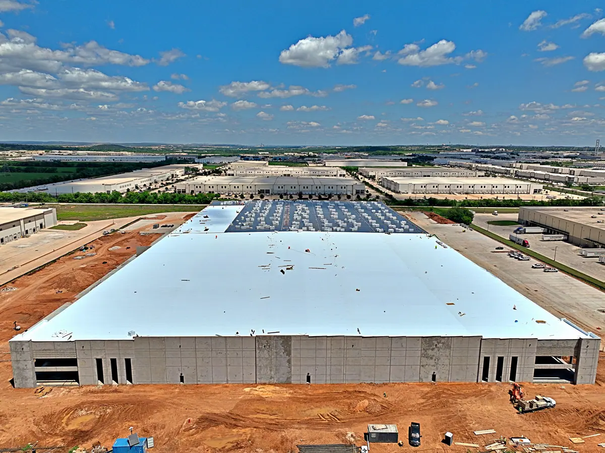 Aerial view of a large new warehouse with a white roof – TPO roofs project gallery