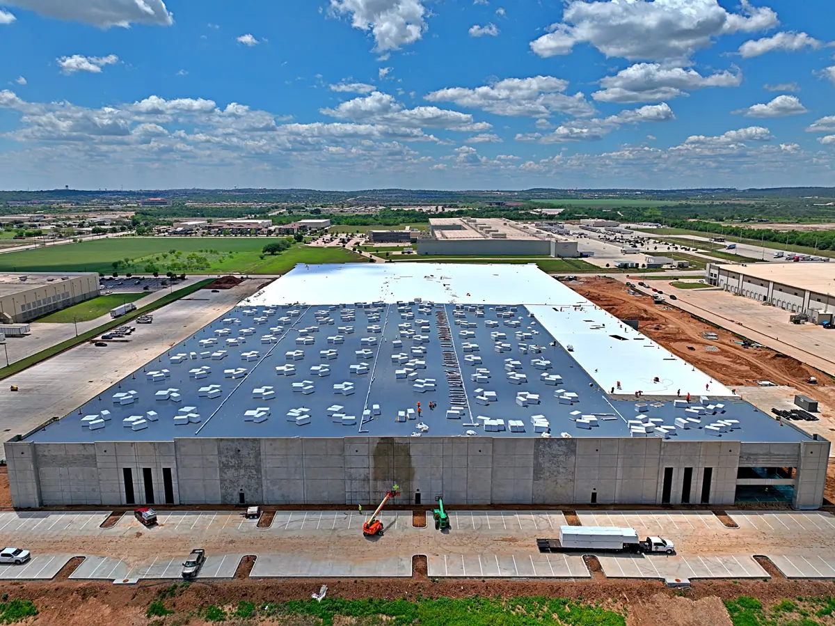 Aerial view of a large warehouse during its TPO roof installation – TPO roofs project gallery