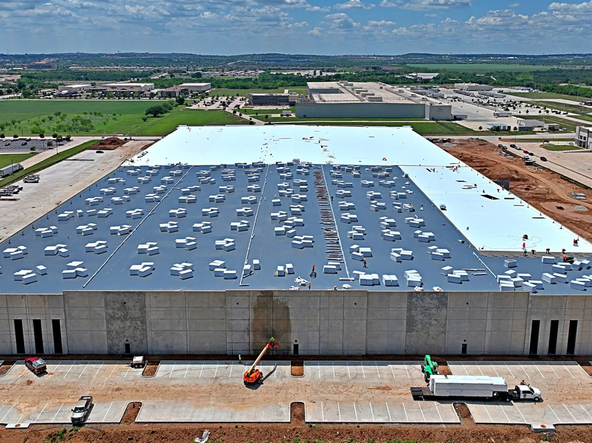 Aerial view of a large warehouse during its TPO roof installation – TPO roofs project gallery