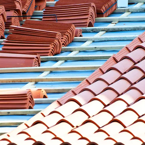 Clay roof tiles being installed on blue battens – roof types in Austin