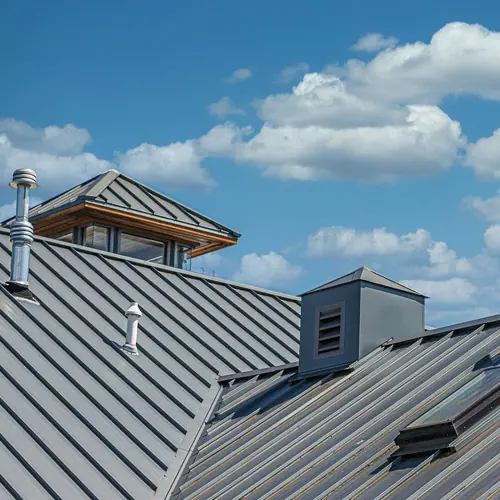 Gray standing seam metal roof with dormers – roof types in Austin